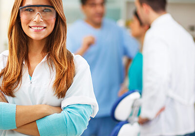 female-dentist-smiling-with-arms-crossed-at-a-dental-office